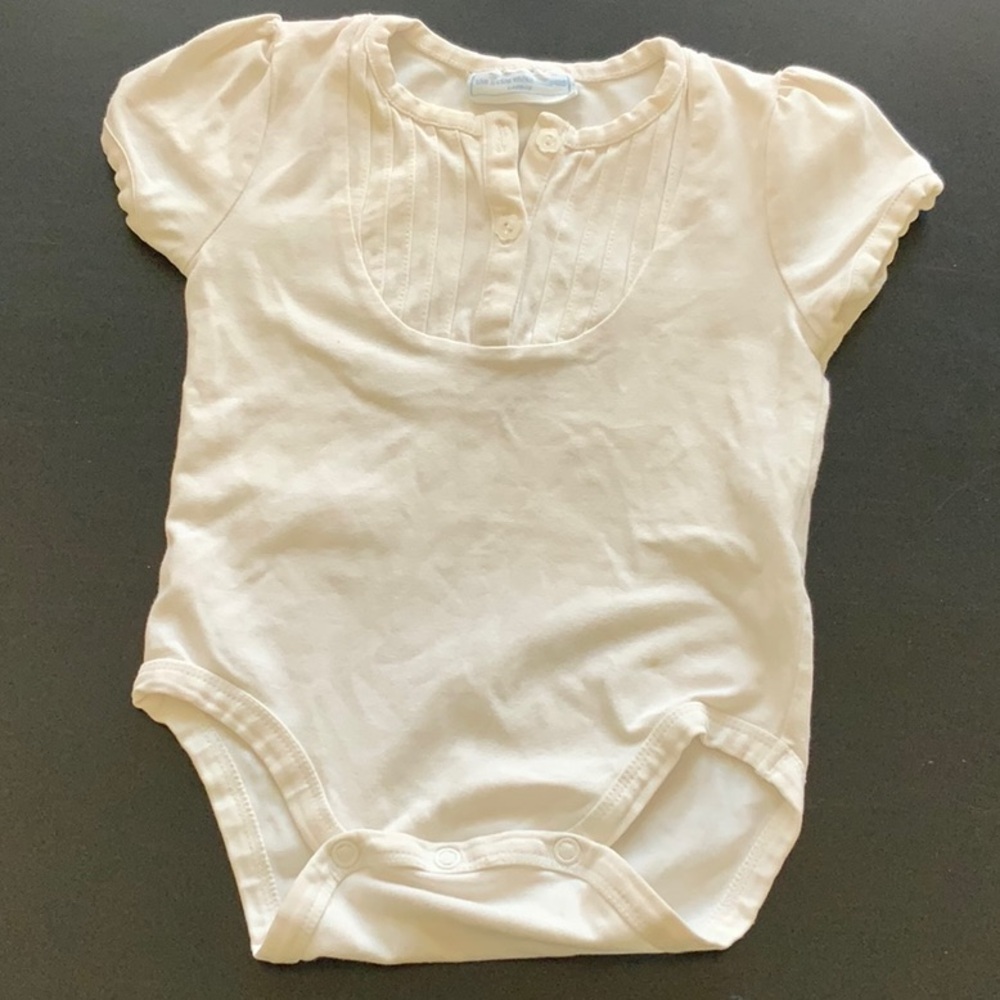 The little white company white baby onesie.
